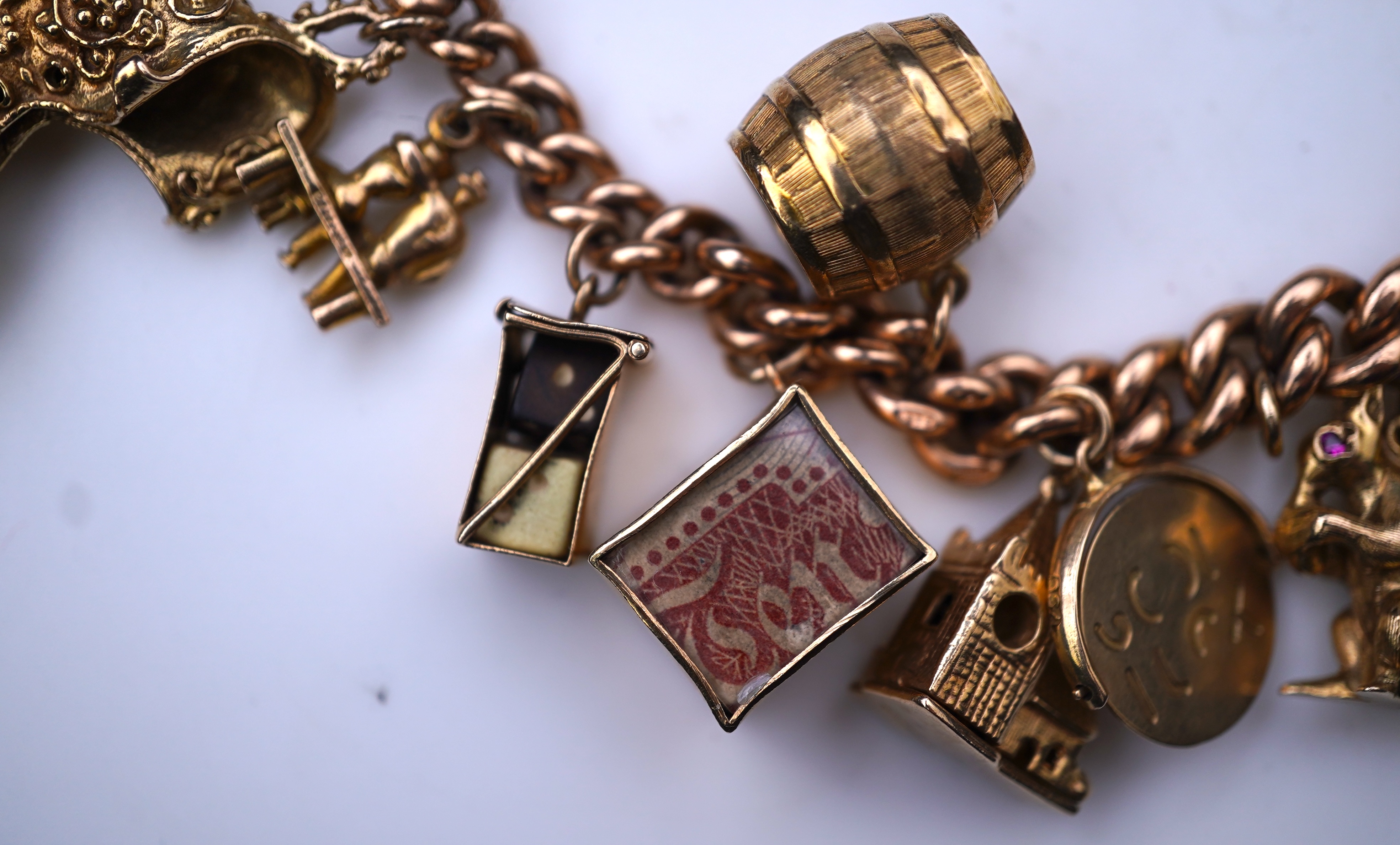 A 9ct gold charm bracelet, mid 20th century